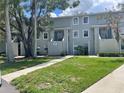 Exterior of Building 7 with green lawn and healthy, flowering trees at 7192 E Bank Dr, Tampa, FL 33617