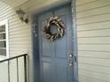 Charming blue front door with a decorative floral wreath at 7192 E Bank Dr, Tampa, FL 33617