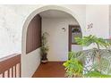 Charming porch with arched entryway and a decorative plant enhancing the welcome to unit 202 at 7614 Radcliffe Cir # 202B, Port Richey, FL 34668
