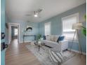 Bright living room with wood floors, plenty of natural light, modern decor, and a ceiling fan at 811 W Peninsular St, Tampa, FL 33603