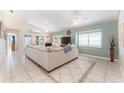Spacious living room featuring high ceilings, tile floors and ample natural light at 835 Symphony Isles Blvd, Apollo Beach, FL 33572