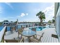 Relaxing outdoor space with pool overlooking water and cozy seating area at 835 Symphony Isles Blvd, Apollo Beach, FL 33572
