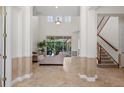 Bright foyer with soaring ceilings, tile flooring, staircase and open floor plan at 8476 Dunham Station Dr, Tampa, FL 33647