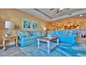 Inviting living room featuring comfortable blue sofas, stylish decor, and an open layout at 100 Bayside Dr # 202, Clearwater Beach, FL 33767