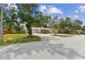 Well-maintained one-story home with a spacious driveway, and green lawn in a mature neighborhood at 10265 130Th St, Largo, FL 33774