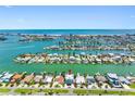 Aerial view of waterfront home with Gulf views, surrounded by canals and lush landscaping at 11260 7Th E St, Treasure Island, FL 33706