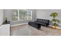 Living room with tile floors, a window, and a black futon at 11325 78Th E St, Parrish, FL 34219