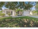 Beautiful single-story home showcasing a well-manicured lawn, mature landscaping, and an attached garage at 11835 Shrewsbury Ln, Parrish, FL 34219