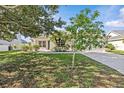 Lovely single-story home with a well-maintained lawn, lush landscaping, and an attached two-car garage at 11835 Shrewsbury Ln, Parrish, FL 34219