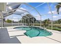 Inviting screened-in pool area with a serene waterfront view, perfect for relaxation and entertainment at 11835 Shrewsbury Ln, Parrish, FL 34219