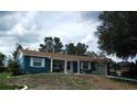 Charming single-story home with blue siding, white trim, and a well-maintained front yard at 12411 Brookside St, Spring Hill, FL 34609