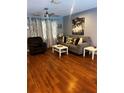 Cozy living room featuring hardwood floors, modern furniture, and stylish decor at 12411 Brookside St, Spring Hill, FL 34609