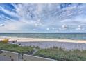 Beautiful sandy beach with calm ocean waters, perfect for relaxation at 14300 Gulf Blvd # 104, Madeira Beach, FL 33708
