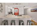 Bright kitchen featuring white cabinets, stainless steel appliances, and a spacious marble countertop at 14300 Gulf Blvd # 104, Madeira Beach, FL 33708