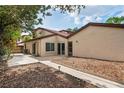 Backyard patio featuring sliding glass doors, a landscaped garden bed, and sidewalk detail at 2095 Sunset Point Rd # 2201, Clearwater, FL 33765
