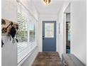Entryway boasts wood floors, a decorative front door, and a large window for natural light at 2095 Sunset Point Rd # 2201, Clearwater, FL 33765