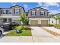 Charming townhomes boast attached garages, nicely landscaped yards, and neutral exteriors at 2513 Sunray Venus Way, Ruskin, FL 33570
