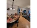 Dining room with chandelier, wood floors and laminate flooring at 2685 Sabal Springs Cir # 202, Clearwater, FL 33761