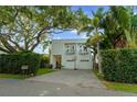 Beautiful modern home with lush landscaping, large trees and a two-car garage at 2711 W Trilby Ave, Tampa, FL 33611