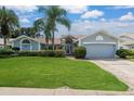Inviting single-Gathering home with manicured lawn, mature landscaping, and an attached two-car garage at 2800 Resnik W Cir, Palm Harbor, FL 34683