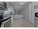 Spacious kitchen featuring modern appliances, granite countertops, and tile flooring at 2812 Tom Brewer Ln, Plant City, FL 33566