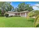 Well-maintained front lawn with mature landscaping at 2875 Lomond Dr, Palm Harbor, FL 34684