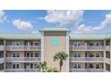 Close up of the condo building showing covered parking and a balcony at 399 150Th Ave # 315, Madeira Beach, FL 33708