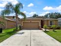 Charming single-story home with attached garage and a long driveway at 4079 Pacente Loop, Wesley Chapel, FL 33543