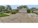 This home has a long driveway and a garage; surrounded by mature landscaping at 4143 Gray Squirrel Ln, New Port Richey, FL 34653
