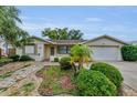 Well-maintained single-story home with tidy landscaping, complemented by a lush green lawn at 4143 Gray Squirrel Ln, New Port Richey, FL 34653