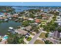 Stunning aerial view of waterfront homes with lush landscaping, canals and easy access to the open bay at 4146 Harbor Hills Dr, Largo, FL 33770