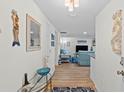 Inviting entryway with stylish decor, wood flooring, and a glimpse into the bright, open living area at 4252 Floramar Ter, New Port Richey, FL 34652