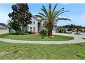 Well-manicured front yard with lush green lawn and mature trees shading the property at 4634 Mapletree Loop, Wesley Chapel, FL 33544