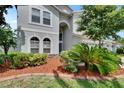 Inviting home with well-maintained landscaping and a mix of greenery and mulch at 4634 Mapletree Loop, Wesley Chapel, FL 33544
