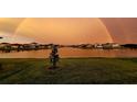 Scenic view of the lake community with a beautiful rainbow spanning across the horizon at 4644 San Martino Dr, Wesley Chapel, FL 33543