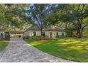 Charming single-story home with a brick driveway and ample parking at 4708 W Neptune St, Tampa, FL 33629