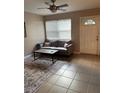 Cozy living room features a comfortable couch and a decorative area rug at 4721 W Wallace Ave, Tampa, FL 33611