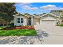 Attractive single-story home with a well-kept lawn and a practical two-car garage under a bright, sunny sky at 6007 Quartz Lake Way, Lithia, FL 33547