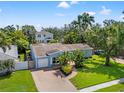 An aerial view of a well-kept home with a brick driveway and manicured lawn at 605 Bosphorous Ave, Tampa, FL 33606
