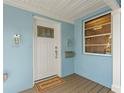 Covered porch with a front door, a new mailbox, and an exterior light at 605 Bosphorous Ave, Tampa, FL 33606