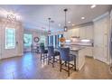 Open kitchen with large island, pendant lights, stainless appliances, and breakfast bar at 621 Winterside Dr, Apollo Beach, FL 33572