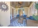 Cozy screened lanai with wood ceiling, fan, comfortable seating, and neutral colors at 621 Winterside Dr, Apollo Beach, FL 33572
