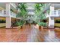 Elegant atrium with lush tropical plants and tiled floors, creating a serene and inviting atmosphere at 6600 Sunset Way # 118, St Pete Beach, FL 33706
