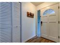 Bright entryway features a closet, hardwood floors, and decorative details at 7320 Hideaway Trl, New Port Richey, FL 34655
