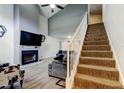 Spacious living room with vaulted ceiling, fireplace, and staircase at 7320 Hideaway Trl, New Port Richey, FL 34655