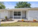 Inviting front porch with lovely landscaping, offering a welcoming entrance to the home at 7814 Judith Cres, Port Richey, FL 34668