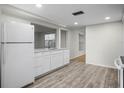 Modern kitchen features white cabinets, sleek countertops, and updated stainless steel appliances at 7814 Judith Cres, Port Richey, FL 34668