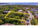 Prime real estate aerial view reveals the shape of land and lake access amid lush greenery and established neighborhood at 7849 Marsh Pointe Dr, Tampa, FL 33635