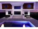 Striking modern home featuring a pool with elegant outdoor seating, perfect for entertaining guests at 7849 Marsh Pointe Dr, Tampa, FL 33635