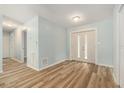 Light-filled entryway with wood-look flooring, fresh paint, and a double-door entry for a grand welcome at 801 Lamont Pl, Temple Terrace, FL 33617